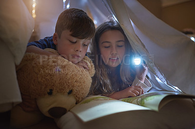 Buy stock photo Night, girl and boy with flashlight for reading book, learning or education for childhood development in home. Siblings, brother or sister bond with storytelling, relax or fantasy for entertainment
