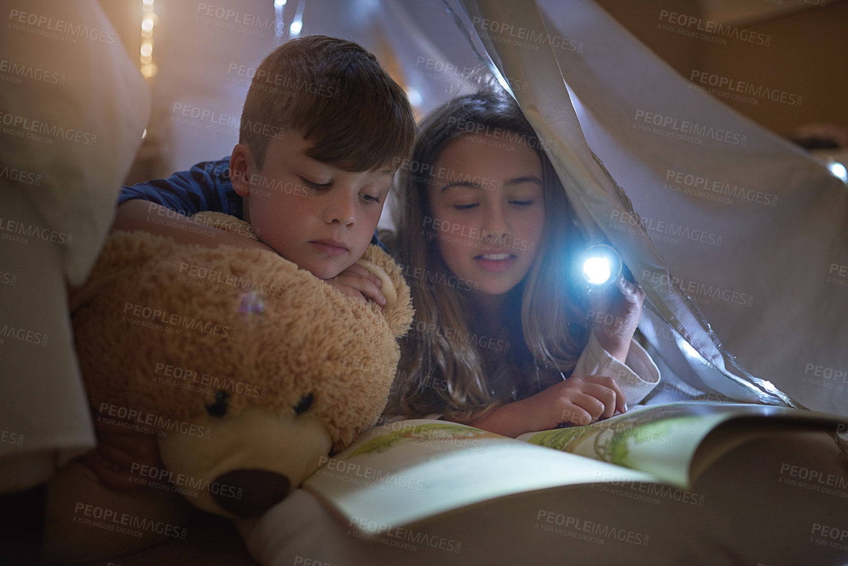 Buy stock photo Night, girl and boy with flashlight for reading book, learning or education for childhood development in home. Siblings, brother or sister bond with storytelling, relax or fantasy for entertainment
