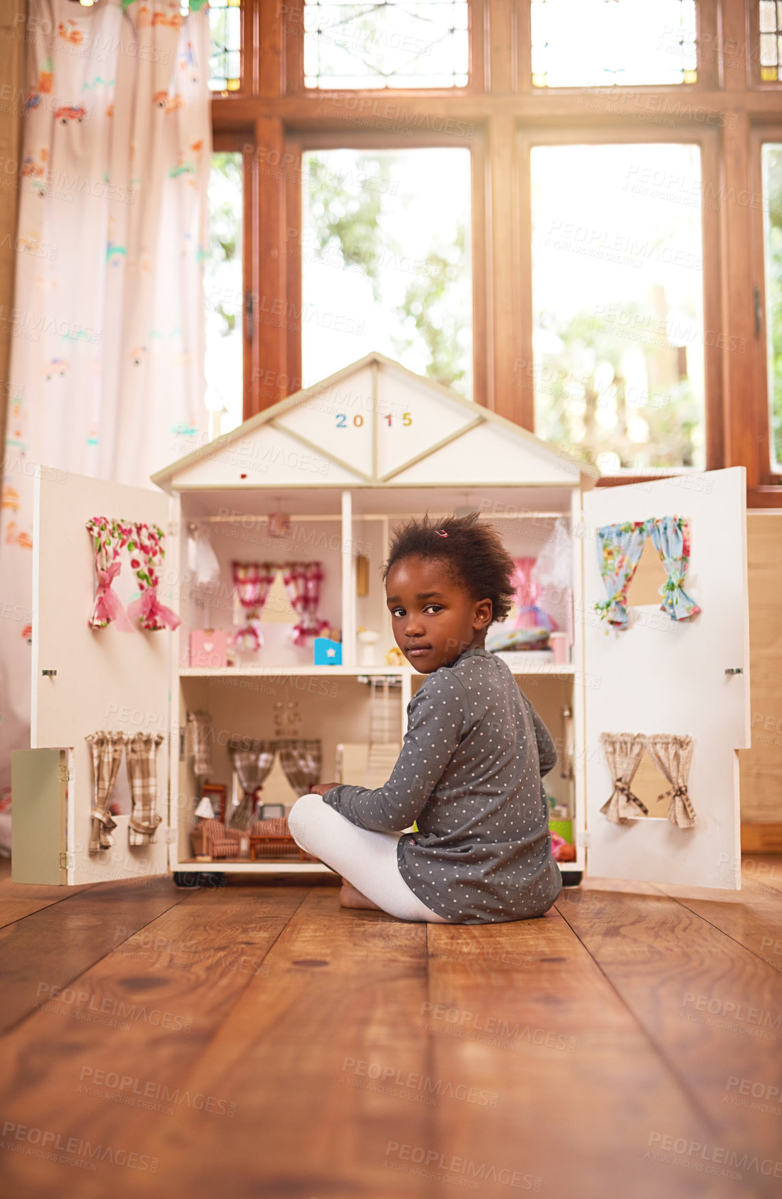 Buy stock photo Portrait of a little girl playing with her dollhouse at home