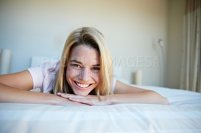 Buy stock photo Portrait shot of a young woman relaxing in her bedroom