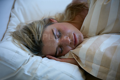 Buy stock photo Shot of a beautiful woman sleeping peacefully in her bed