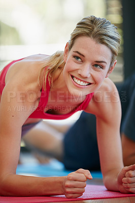 Buy stock photo Cropped shot of a sporty young woman working out at home