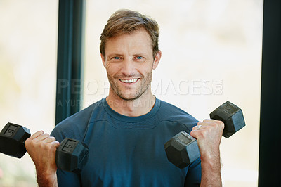 Buy stock photo Portrait of a sporty man doing weight training
