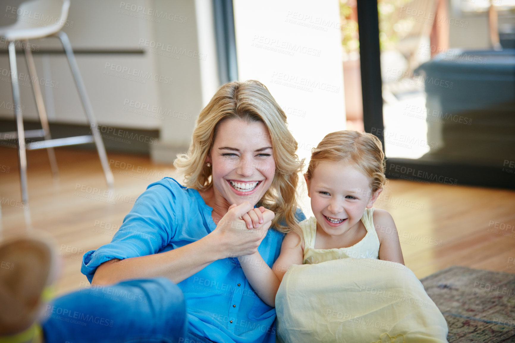 Buy stock photo Shot of a young mother playing with her daughter in their home