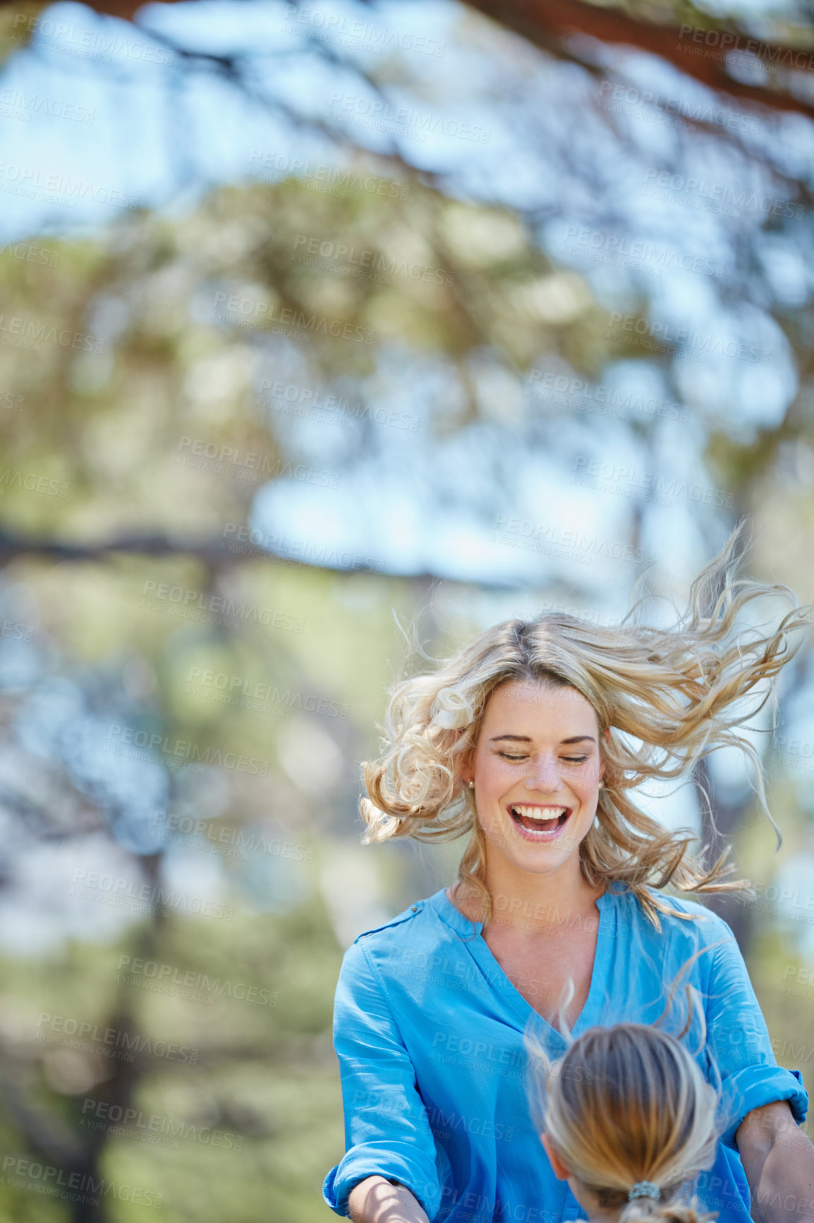 Buy stock photo Shot of a young mother playing on the trampoline with her daughter outside