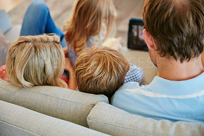 Buy stock photo Rear view shot of a family relaxing together at home