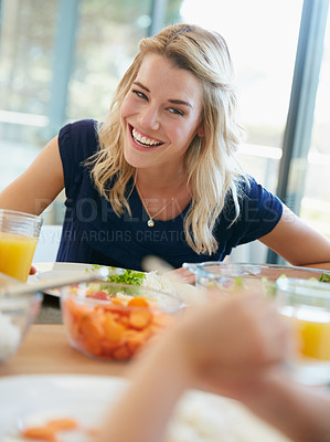 Buy stock photo Cropped shot of a young woman enjoying a meal at home