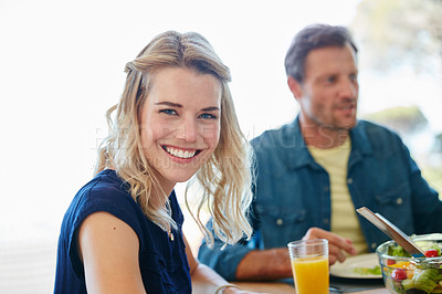 Buy stock photo Portrait of a young woman enjoying a meal together with her husband at home