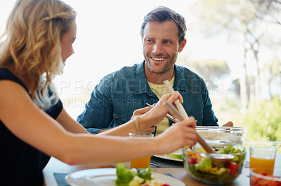 Buy stock photo Cropped shot of a couple enjoying a meal together at home