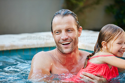 Buy stock photo Cropped shot of a father and daughter swimming in a pool together