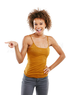 Buy stock photo Studio shot of an attractive young woman pointing towards something