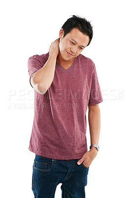 Buy stock photo Studio shot of a young man rubbing his sore neck against a white background