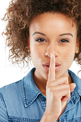 Buy stock photo Shot of a young woman keeping her finger on her lips against a white background