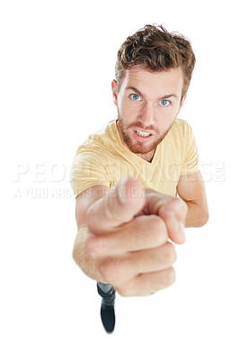 Buy stock photo Studio portrait of an angry young man pointing upwards while standing against a white background