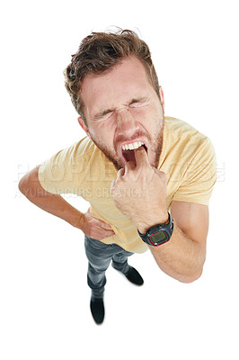 Buy stock photo Studio portrait of an angry young man sticking his finger down his throat against a white background