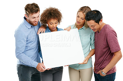 Buy stock photo Studio shot of a group of friends holding up a blank sign against a white background