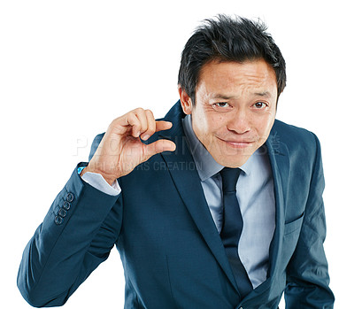 Buy stock photo Portrait, hand or small with a business asian man in studio isolated on a white background to measure size. Face, gesture or little and a male employee giving a review or feedback with a finger scale