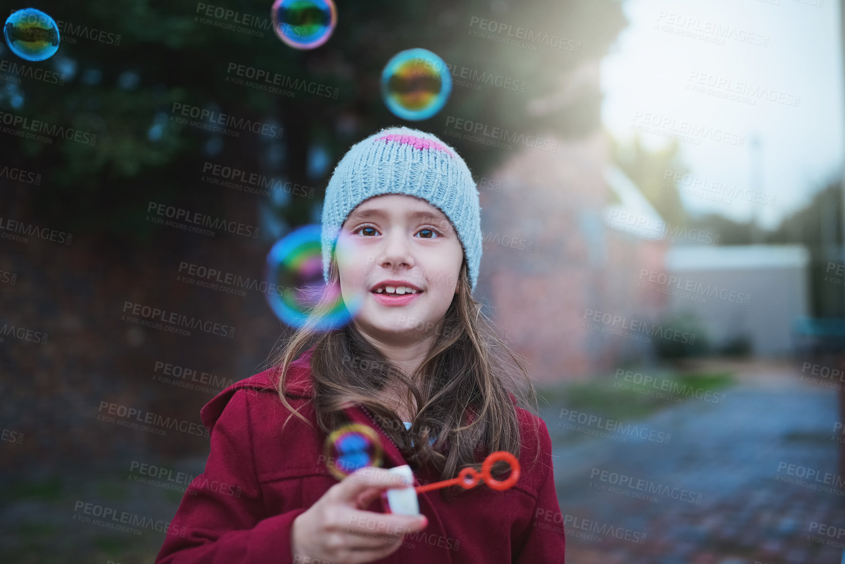 Buy stock photo Child, happy and blowing bubbles for outdoor playing with holiday fun in winter, childhood or development. Girl, kid and smiling outside in cold weather as preschool student, joyful or positivity