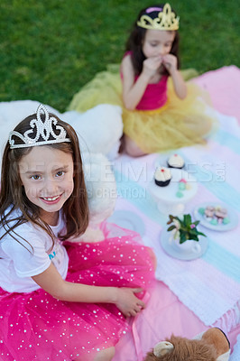 Buy stock photo Portrait of a little girl having a picnic with her sister outside