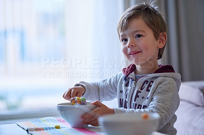 Buy stock photo Cropped shot of a little boy eating breakfast at home