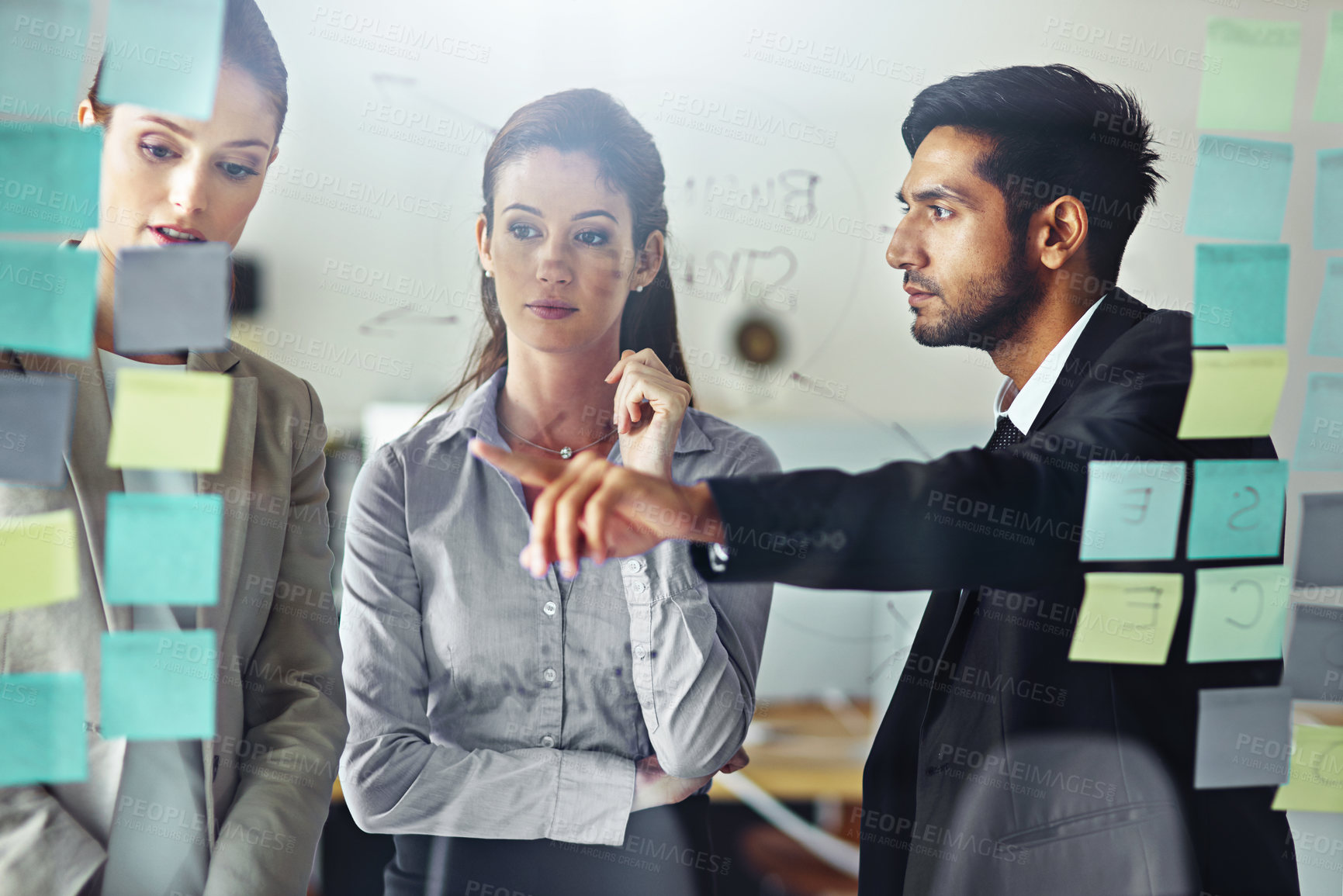 Buy stock photo Business people, planning and talking in office with glass wall for brainstorming, teamwork and collaboration. Sticky notes, idea and employees working together in meeting with transparent board