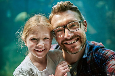 Buy stock photo Portrait of a father and his little daughter taking a selfie together at an aquarium