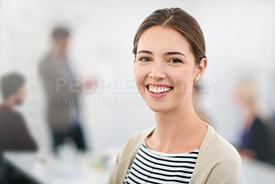 Buy stock photo Portrait of a young businesswoman in an office with colleagues in the background