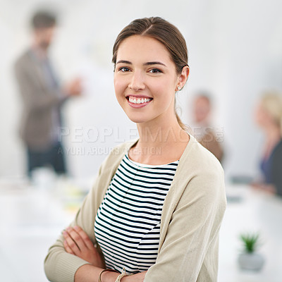 Buy stock photo Portrait of a young businesswoman in an office with colleagues in the background
