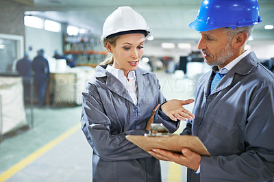 Buy stock photo Man, woman and discussion with checklist in factory for quality inspection or safety checks and process monitoring. Team, inventory and clipboard for manufacturing information in printing warehouse.