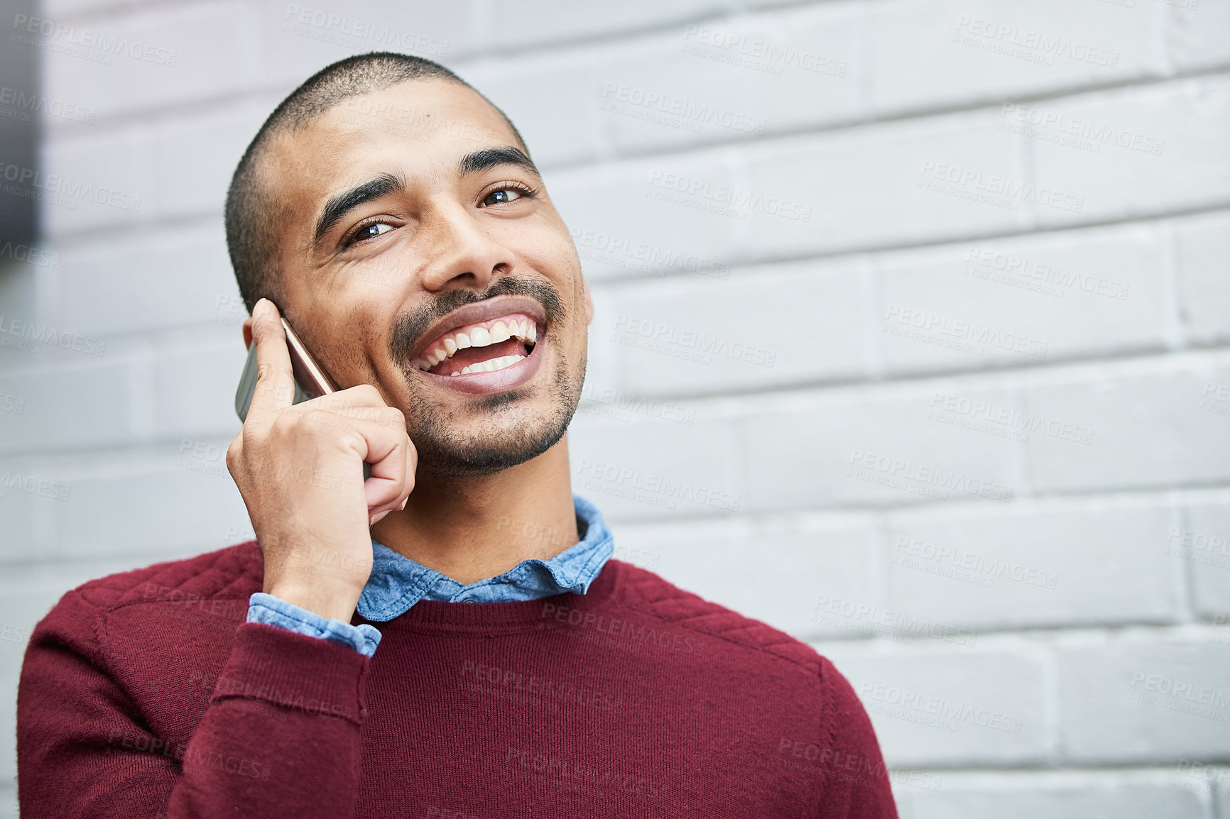 Buy stock photo Cropped shot of a young businessman talking on a cellphone outside