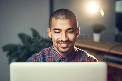 Buy stock photo Cropped shot of a young designer working late on a laptop in an office
