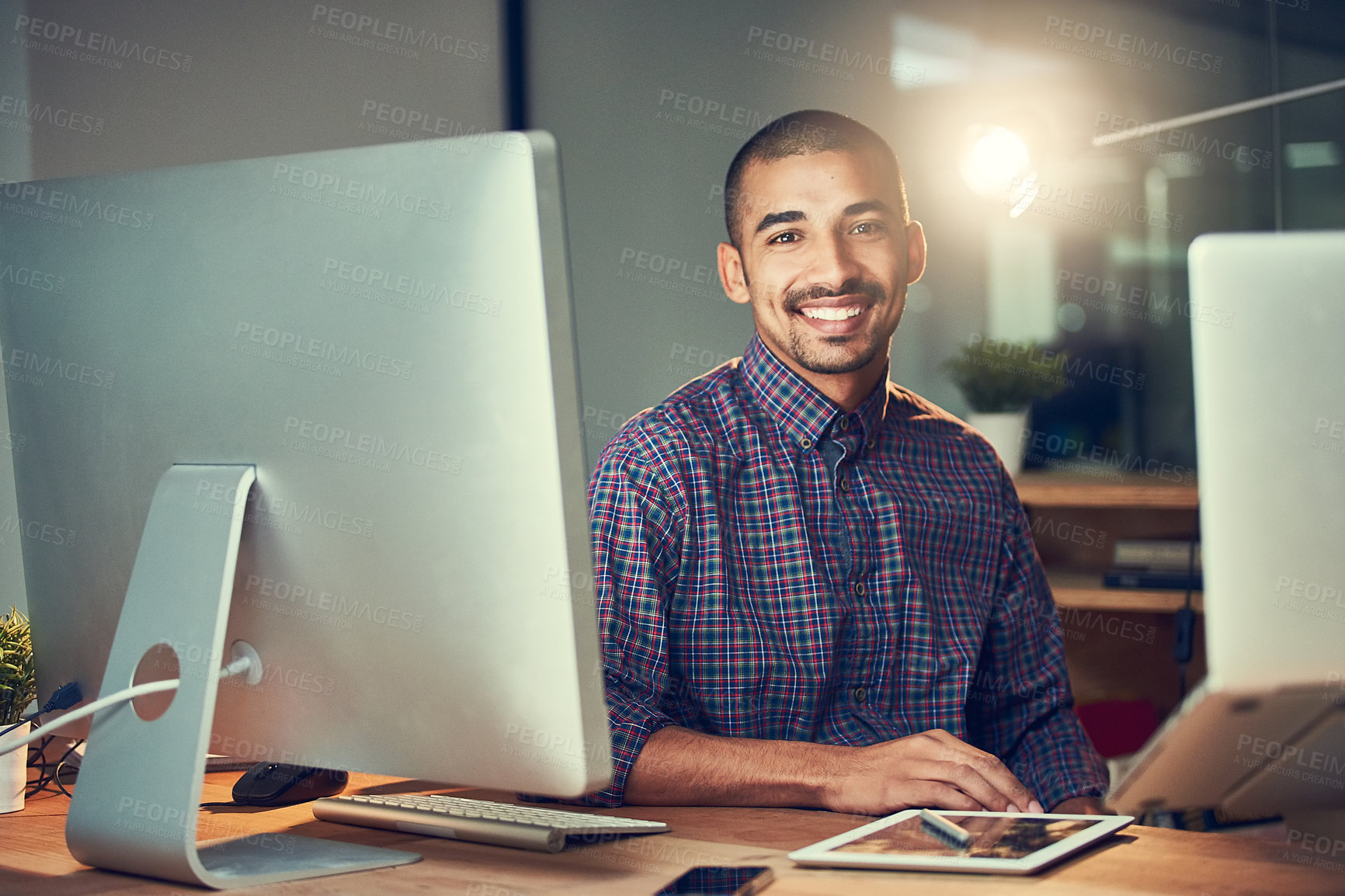 Buy stock photo Portrait of a young designer working late in an office