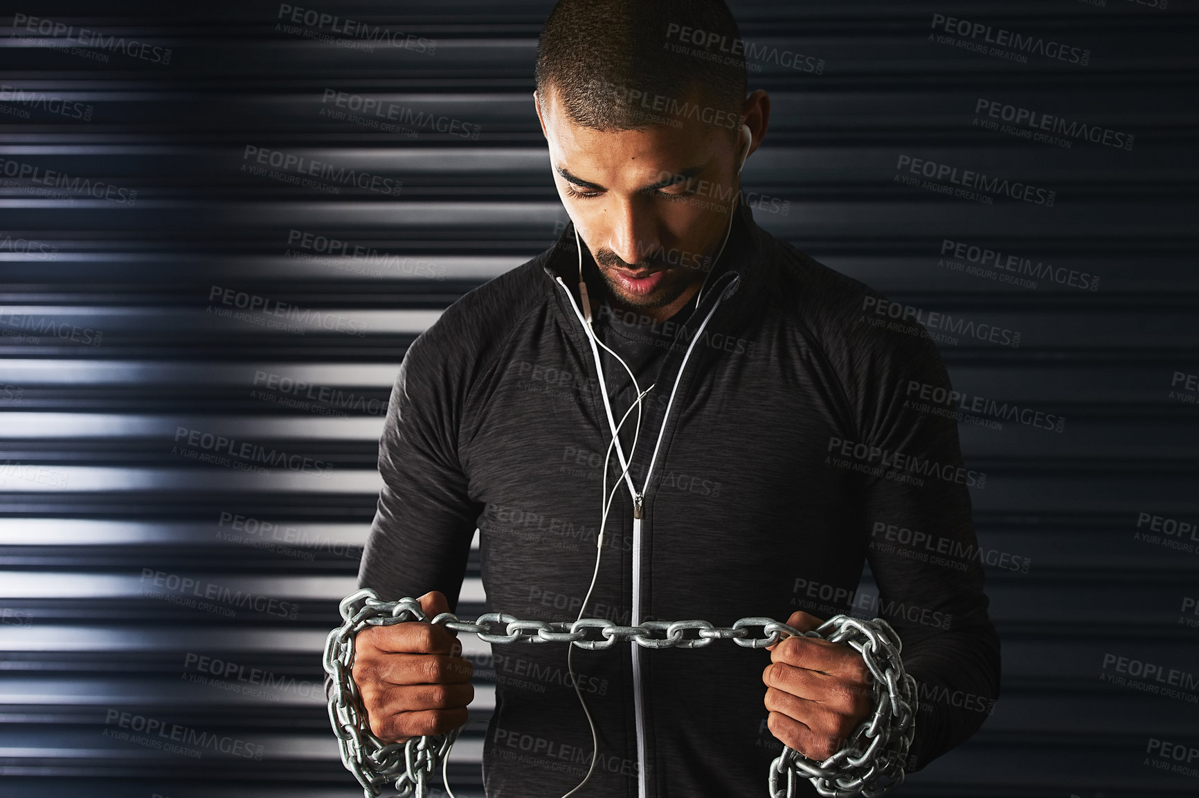 Buy stock photo Man, metal chain and workout in gym, earphones and listen to music for motivation in exercise. Male person, power and iron rope for training or fitness, strong and athlete for muscle  and audio