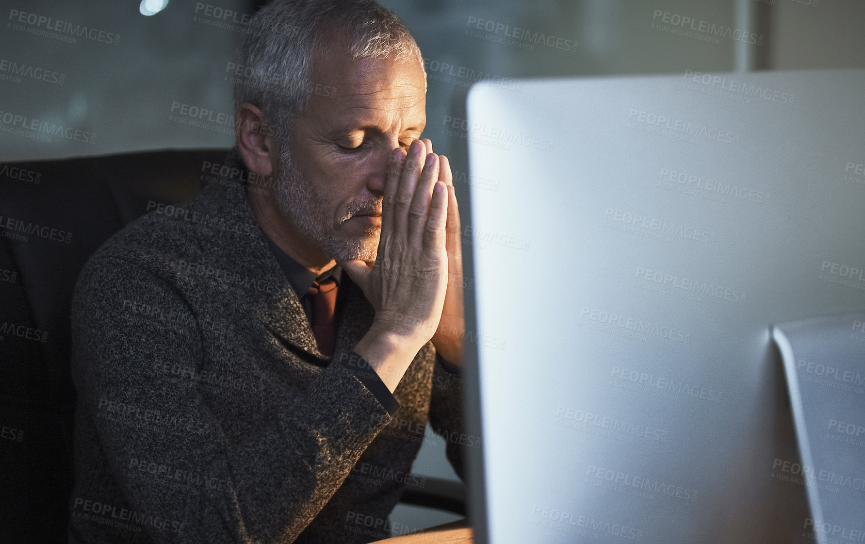 Buy stock photo Cropped shot of a mature businessman looking stressed while working late at the office