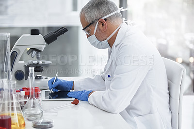 Buy stock photo Shot of a researcher at work on a microscope in a lab
