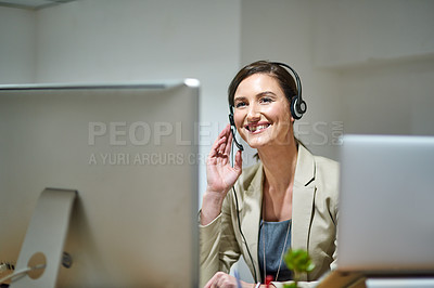 Buy stock photo Shot of a professional woman using a computer and headset at her desk
