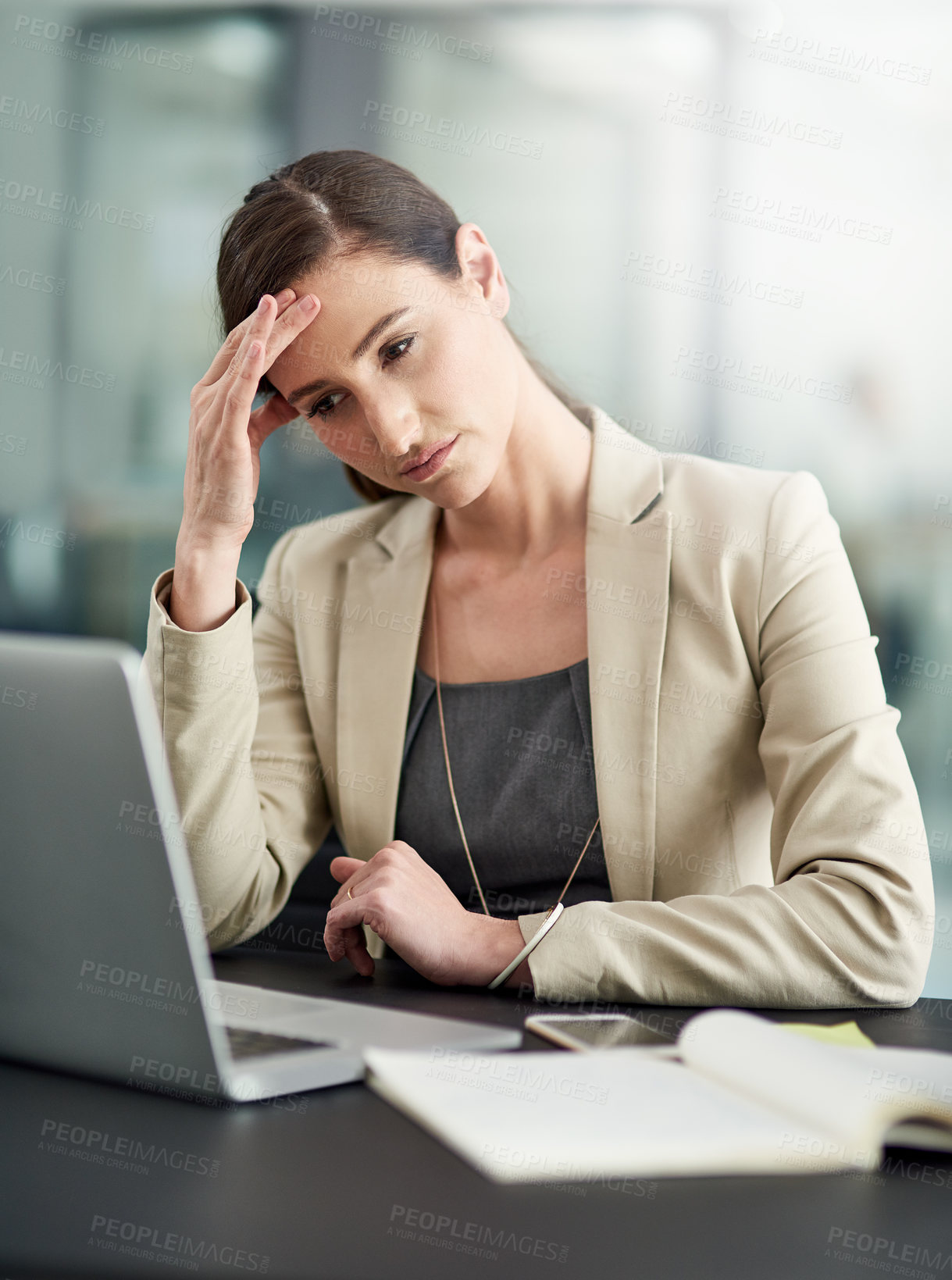 Buy stock photo Shot of a businesswoman looking stressed out at her office desk