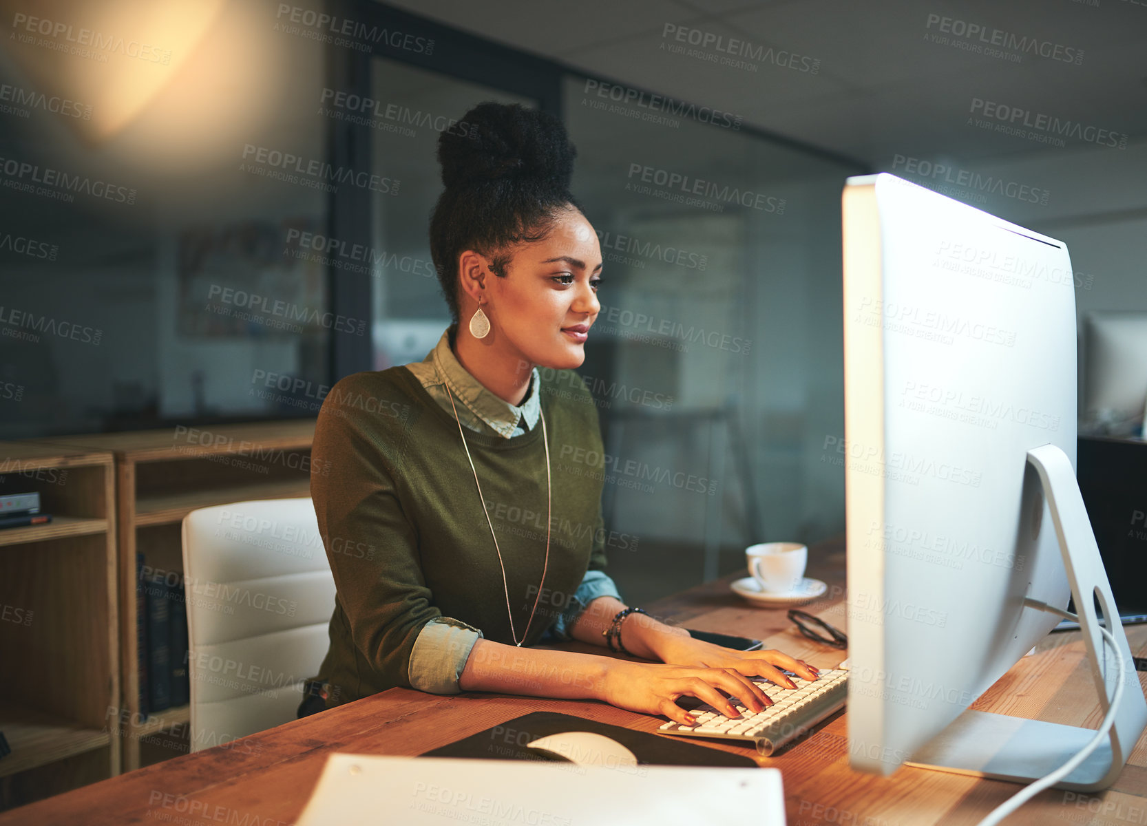 Buy stock photo Shot of an attractive young woman working on her computer in the office