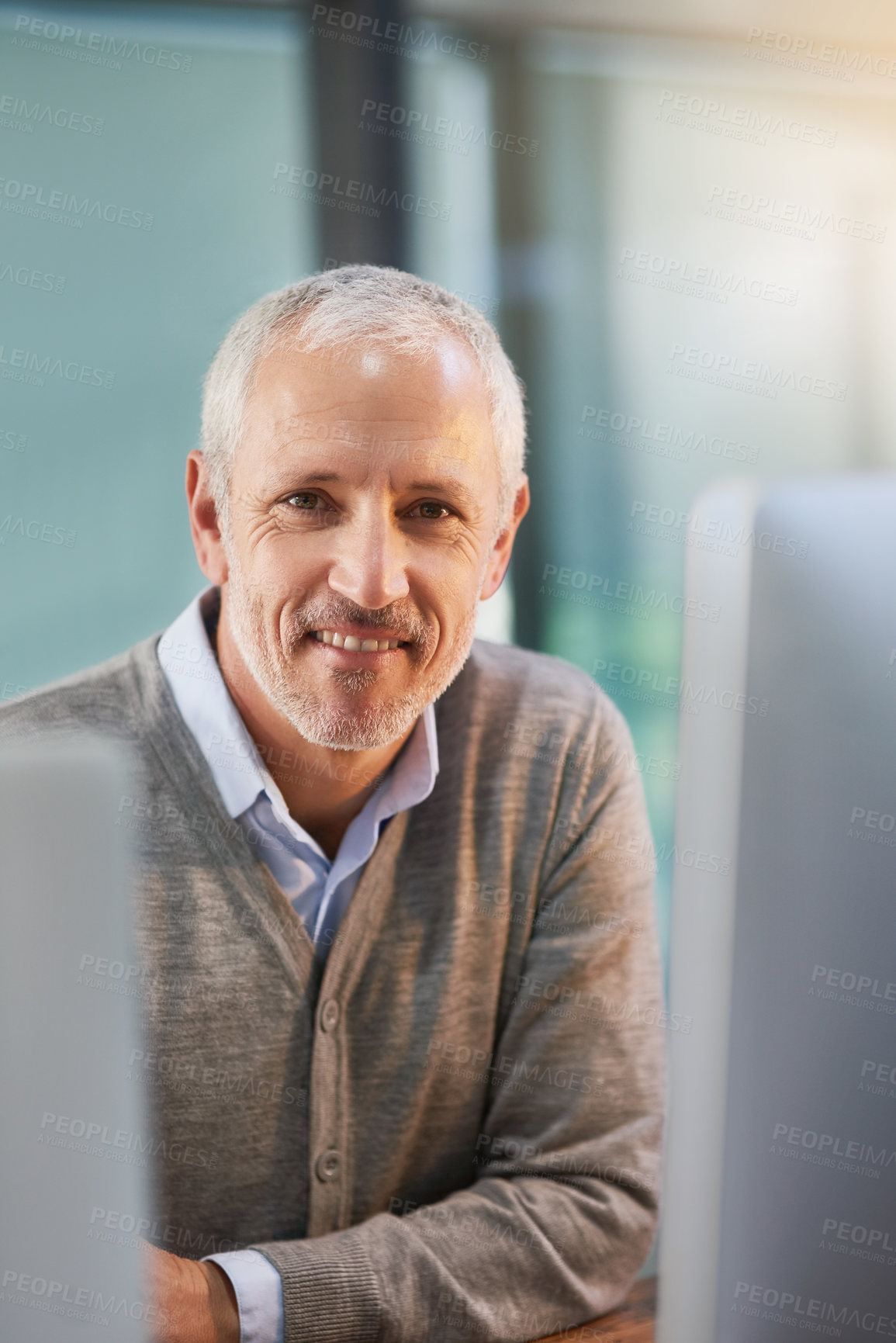 Buy stock photo Cropped portrait of a mature businessman sitting in his office