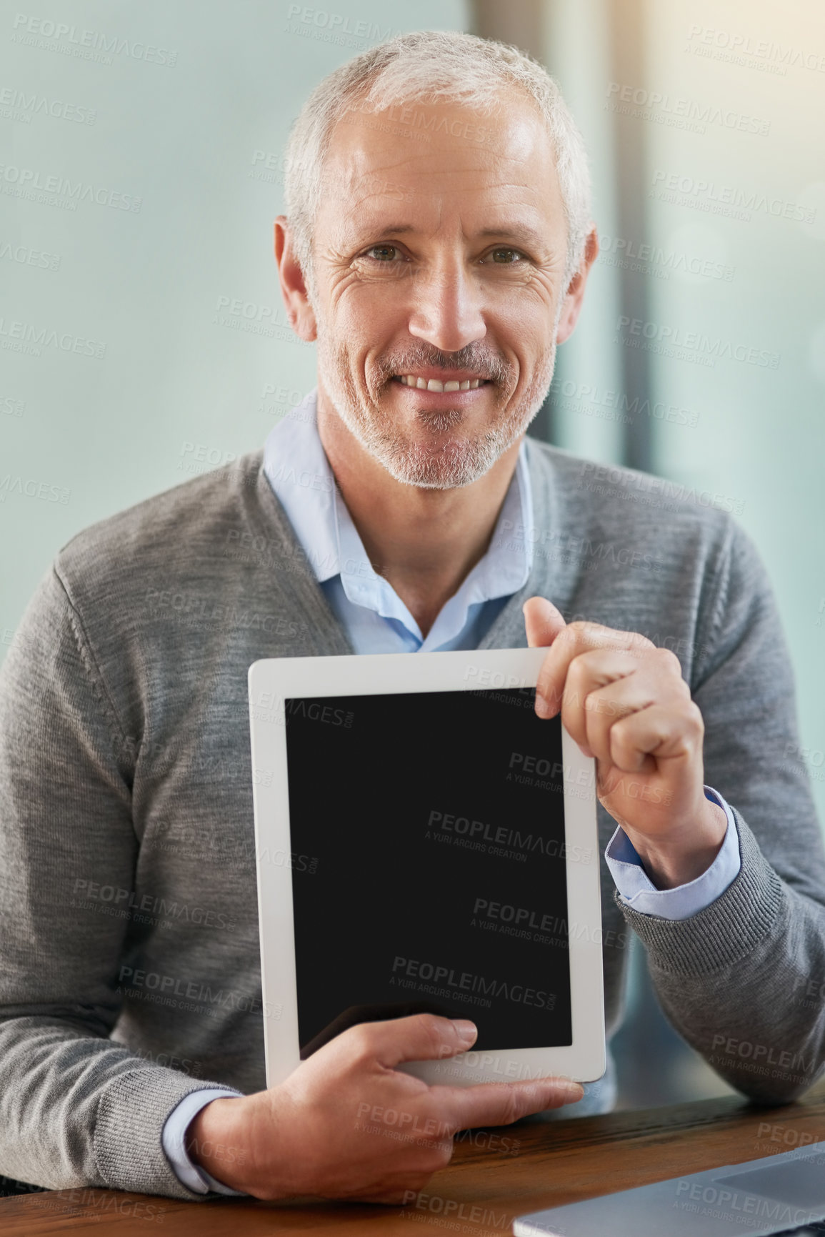Buy stock photo Portrait of a mature businessman showing you his digital tablet in the office