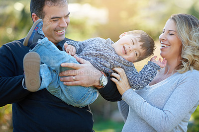 Buy stock photo Cropped shot of parents bonding with their little boy outside