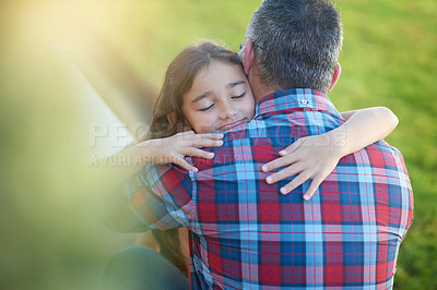 Buy stock photo Shot of a happy little girl hugging her father at home