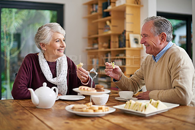 Buy stock photo Cropped shot of a senior couple having lunch at home