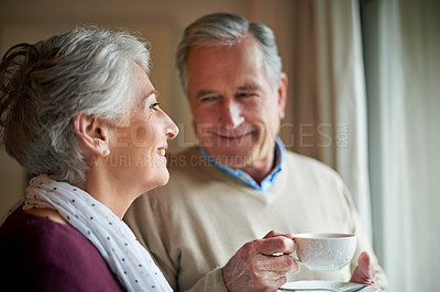 Buy stock photo Shot of a senior couple enjoying soma alone time at home