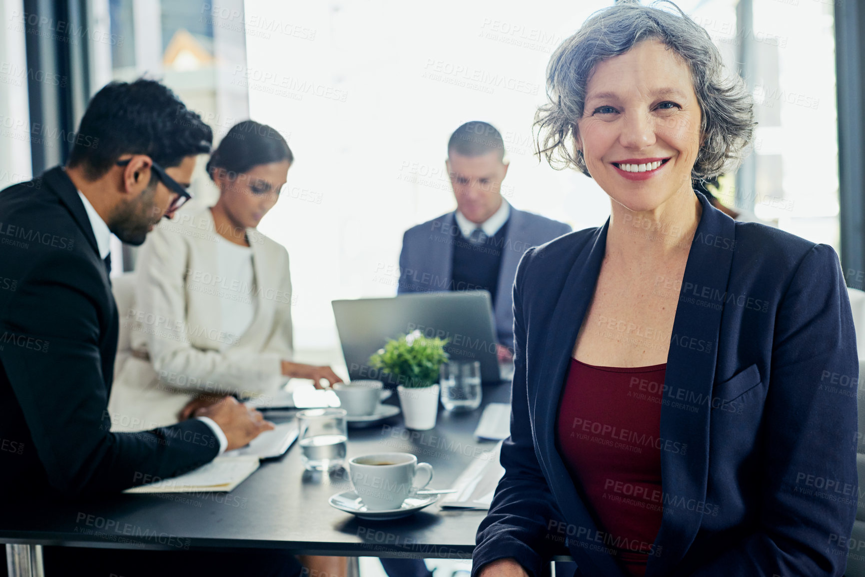 Buy stock photo Portrait of a businesswoman in an office with her colleagues in the background