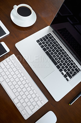 Buy stock photo High angle shot of various digital devices on a table