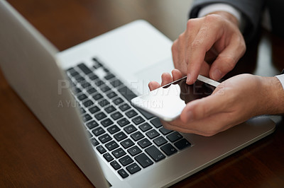 Buy stock photo Cropped shot of corporate businessmen texting on a cellphone