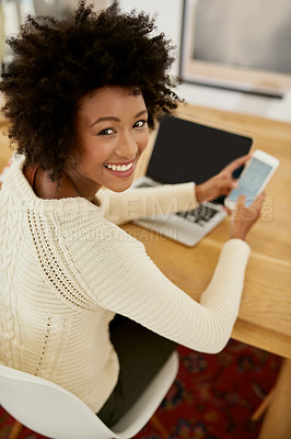 Buy stock photo Portrait of an attractive young using her cellphone and laptop at home