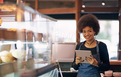 Buy stock photo Portrait of a young entrepreneur using a digital tablet in her business