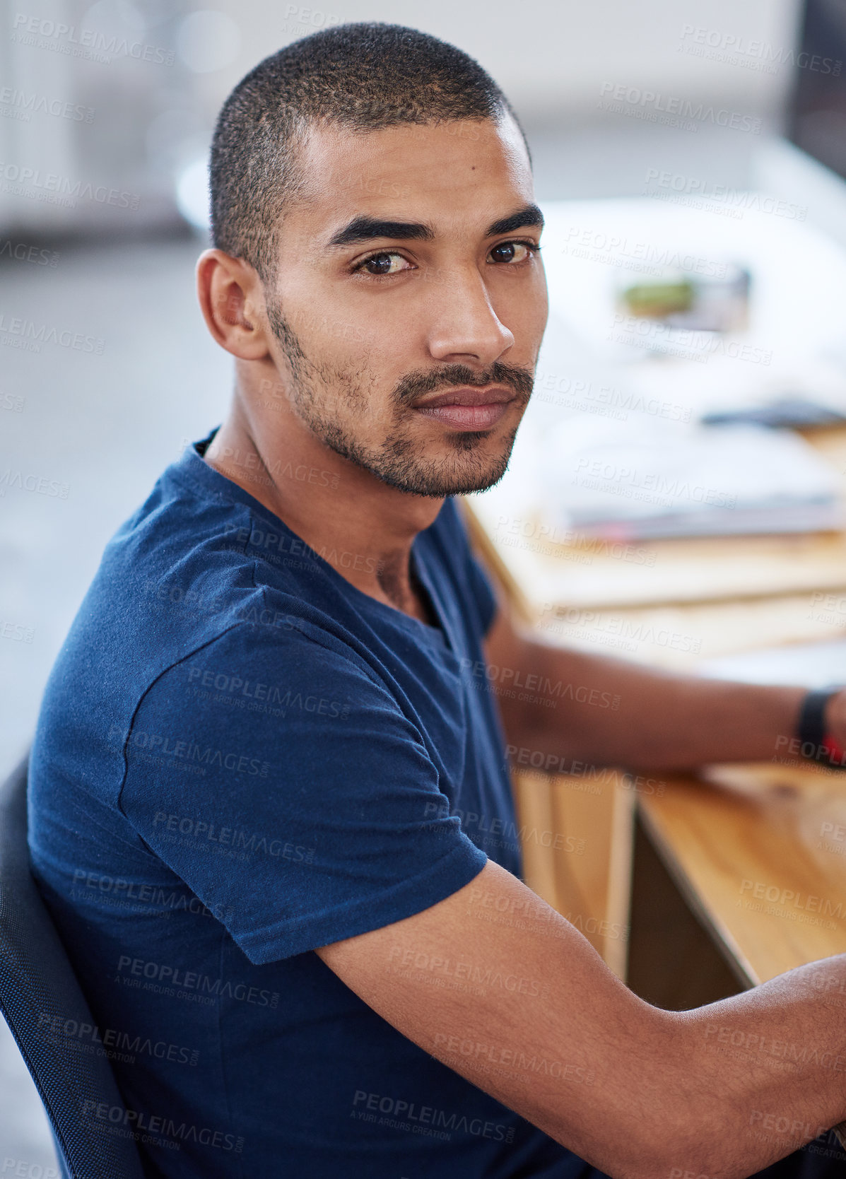 Buy stock photo Portrait, serious and business man in office at desk of creative startup for career or job of male person in Brazil. Face, professional and confident entrepreneur at table, designer and employee
